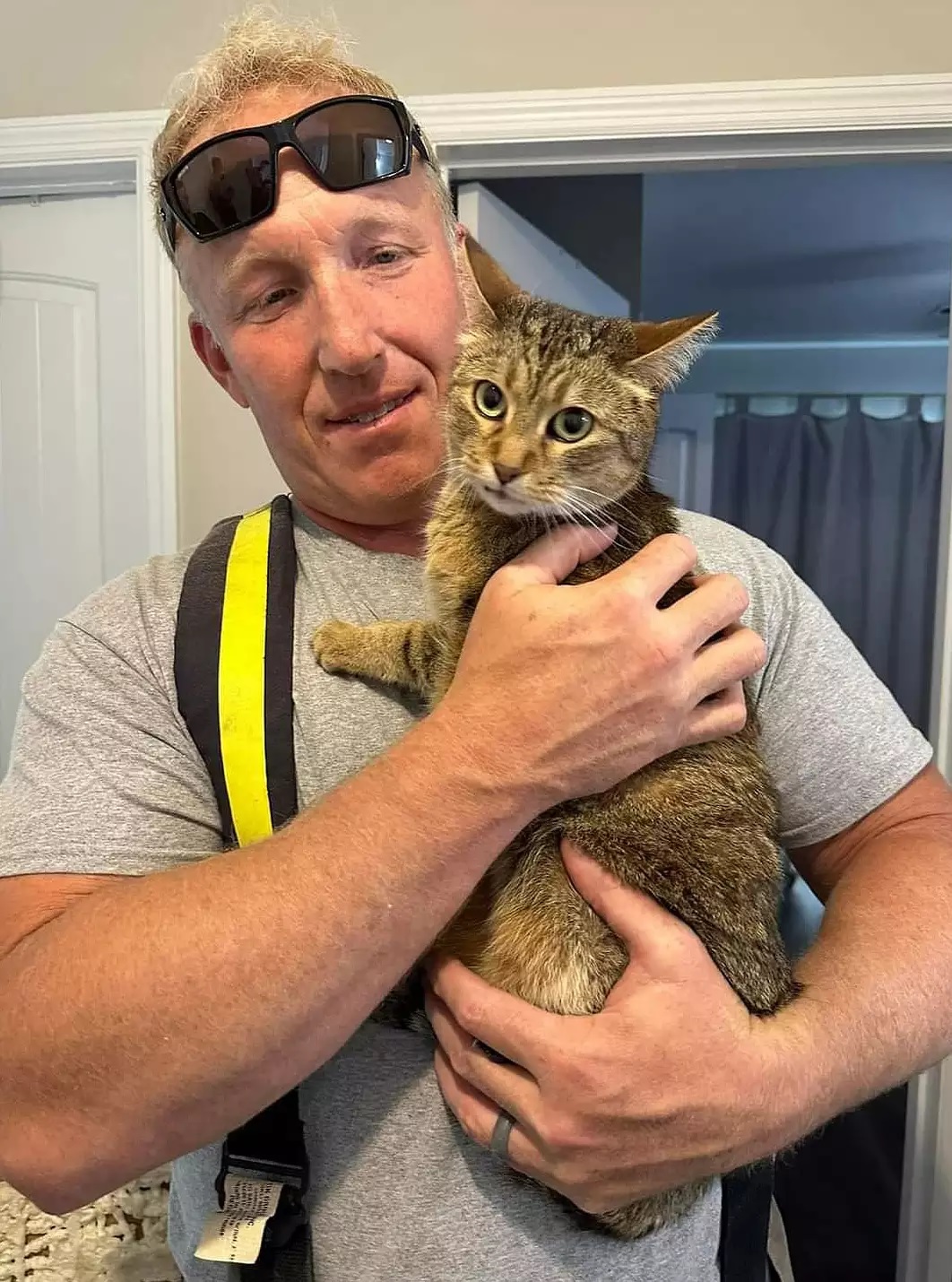 firefighter holding cat