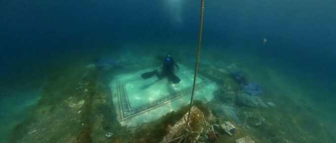an underwater archaeologist works on ancient tile mosaic