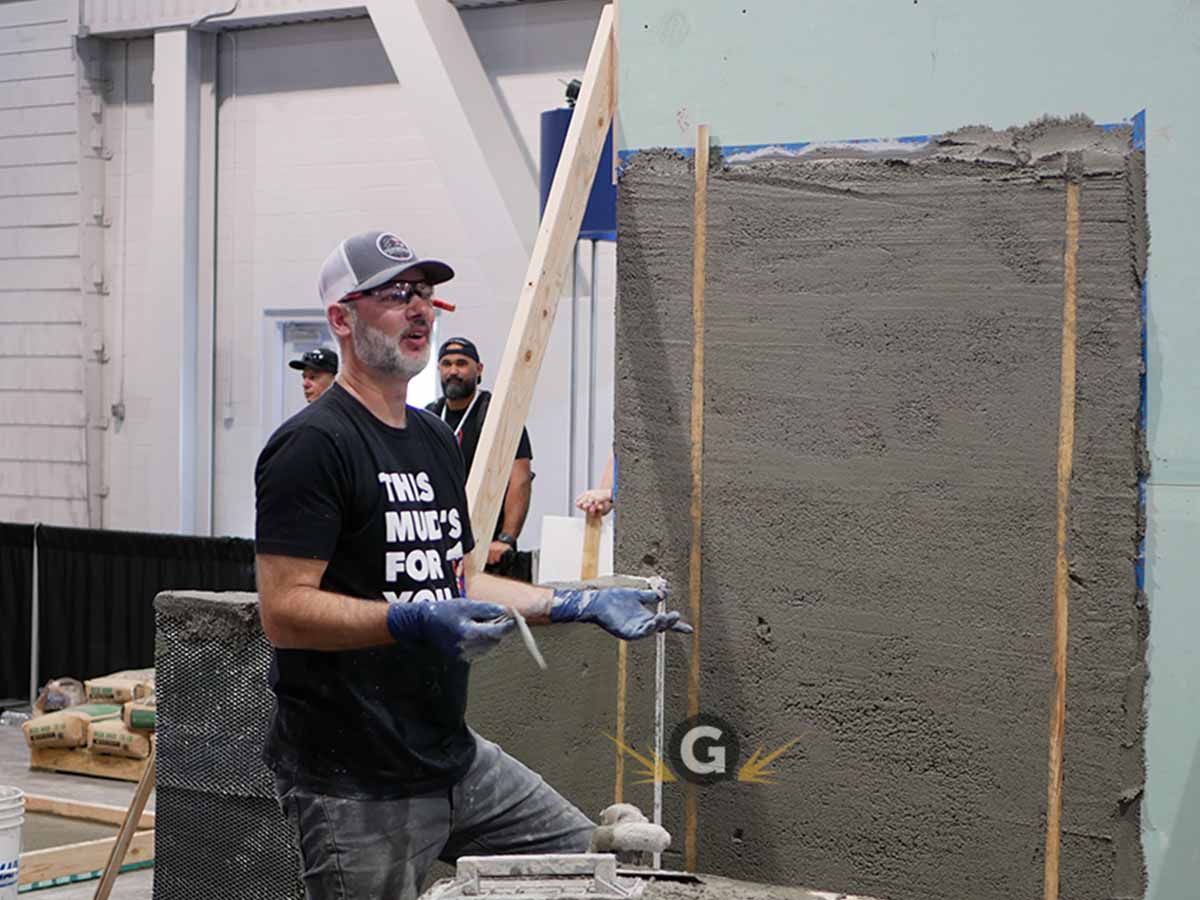 Tile setter Joe Lima taking the ACT mud walls exam at Coverings 2022 Las Vegas